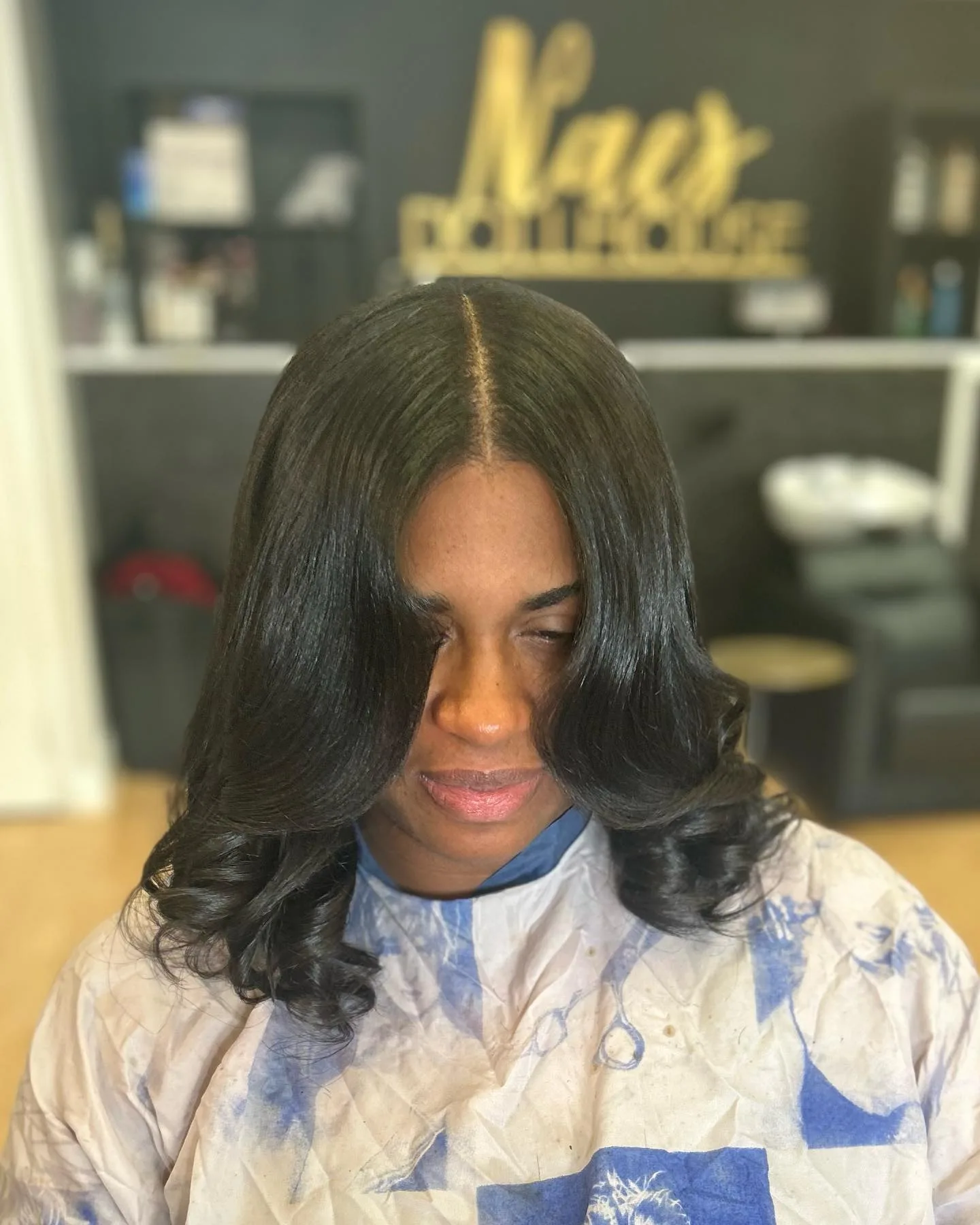 Silk press hairstyle with a smooth, polished finish.